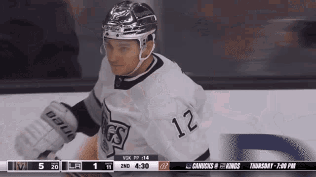 a hockey player with the number 12 on his jersey is on the ice