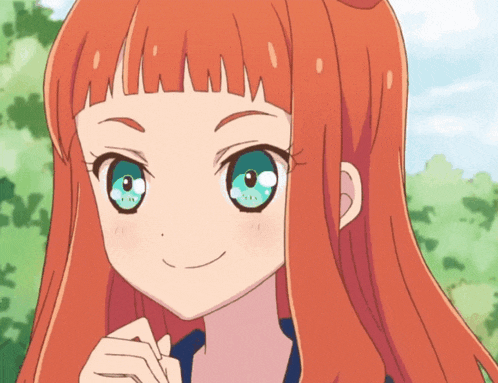 a girl with long red hair and blue eyes is smiling