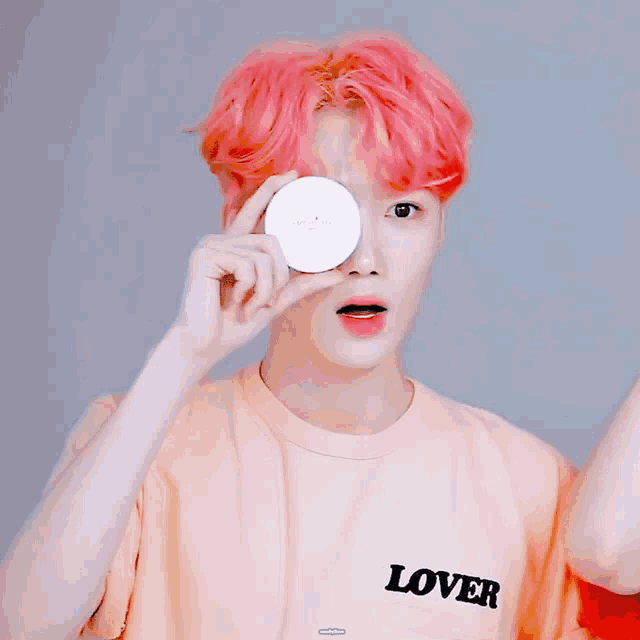 a boy with pink hair is wearing a lover shirt