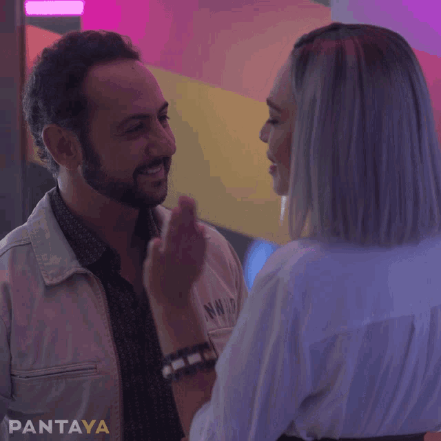 a man and a woman are looking at each other with pantaya written on the bottom right