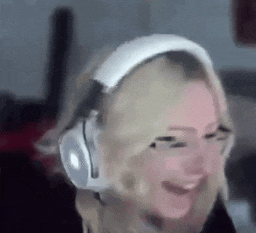 a woman wearing headphones is laughing and smiling .