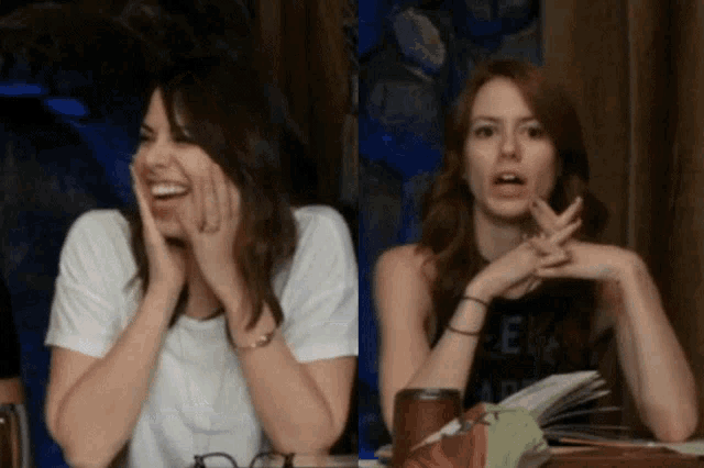 two women sitting next to each other with one wearing a black shirt that says " geek "