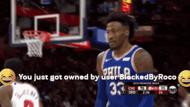 a philadelphia basketball player is standing in front of a basketball net
