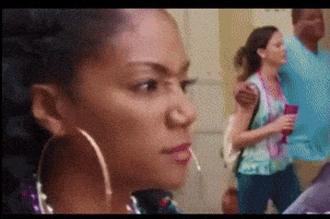 a woman wearing hoop earrings is looking at something