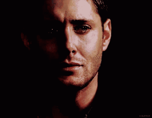 a close up of a man 's face with tears coming out of his eyes .