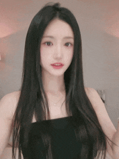 a woman with long black hair is wearing a black top and necklace