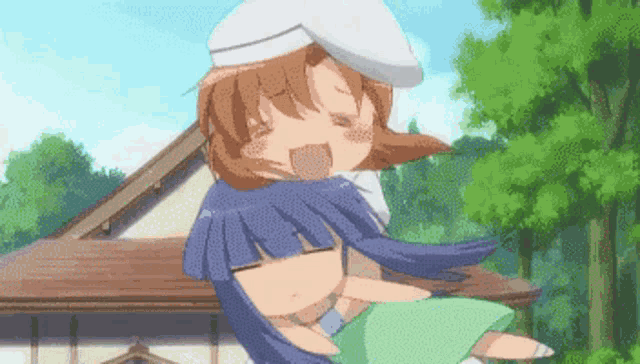 a girl in a white hat holds another girl in her arms