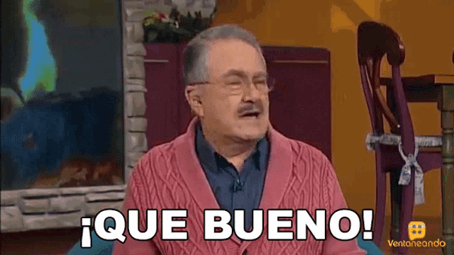 a man in a pink sweater says que bueno in spanish
