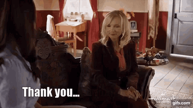 two women are sitting on a couch and one of them says thank you