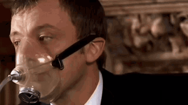 a close up of a man wearing an oxygen mask .