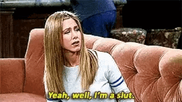 a woman is sitting on a couch and saying yeah well i 'm a slut