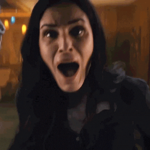 a close up of a woman 's face with a surprised look on her face