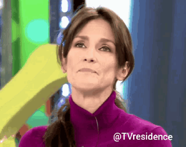 a woman in a purple sweater with the hashtag @tvresidence on the bottom
