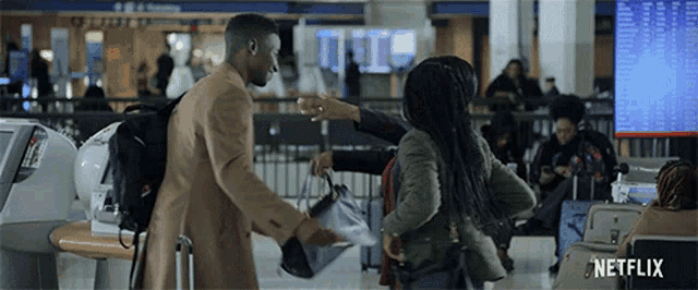 a netflix ad shows a man helping a woman with her luggage