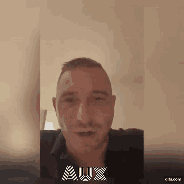 a man with a mustache is talking in a video with the word aux on the bottom