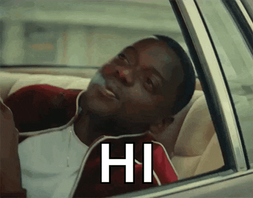 a man is sitting in the back seat of a car smoking a cigarette and saying hi