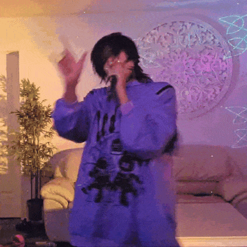 a person wearing a purple shirt that says ' all ' on it