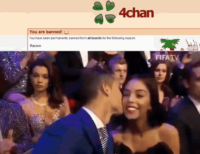 a man kisses a woman in front of a screen that says you are banned