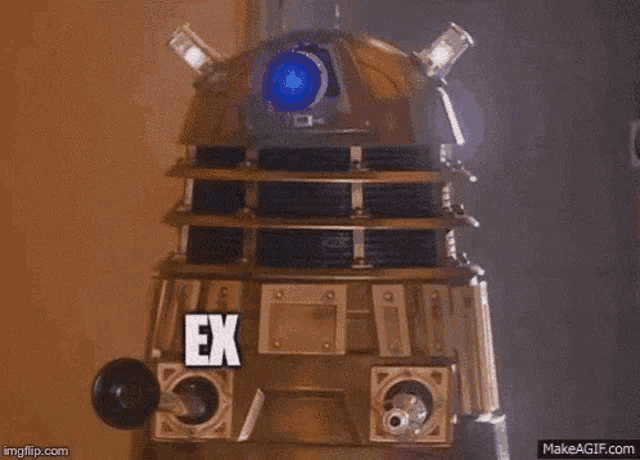 a dalek from doctor who is standing in a dark room and says `` externi '' .
