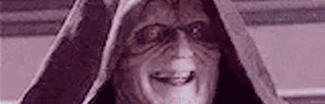 a close up of a person wearing a hooded robe and sunglasses .