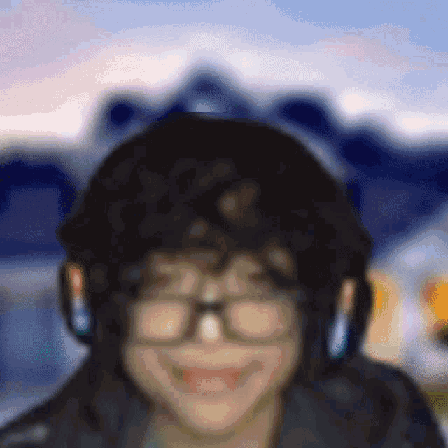 a blurry picture of a woman wearing glasses and headphones
