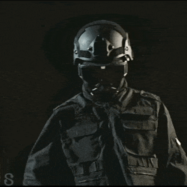 a man wearing a helmet with the letter s on the bottom left