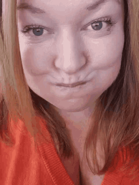 a close up of a woman making a face with her mouth open