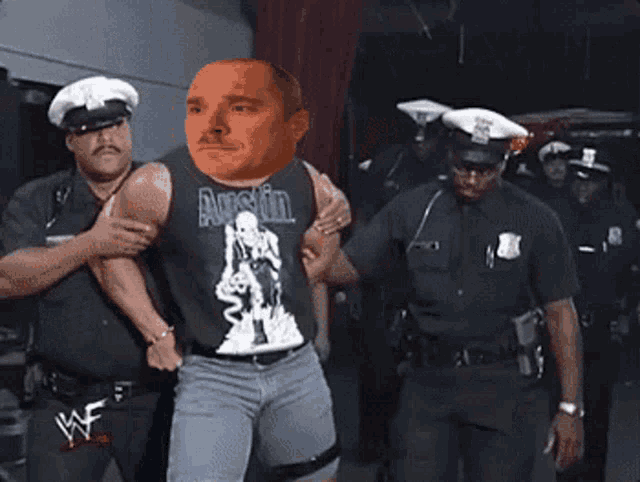 a man wearing a tank top that says austin is being escorted by police