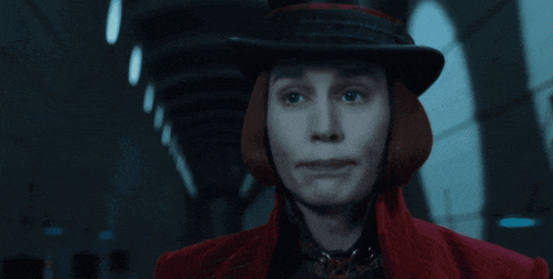 a man wearing a top hat and a red coat