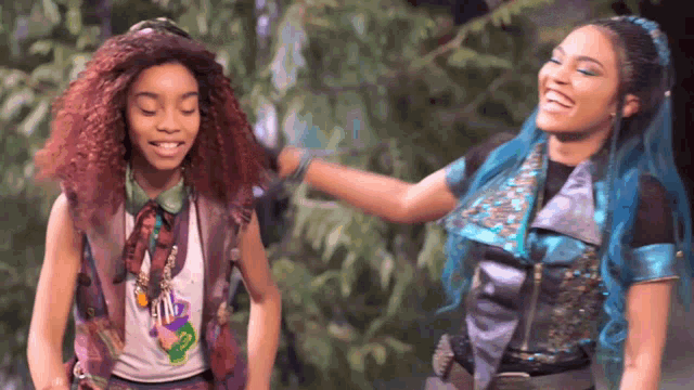 two girls are standing next to each other and one has a t-shirt that says ' ariel ' on it