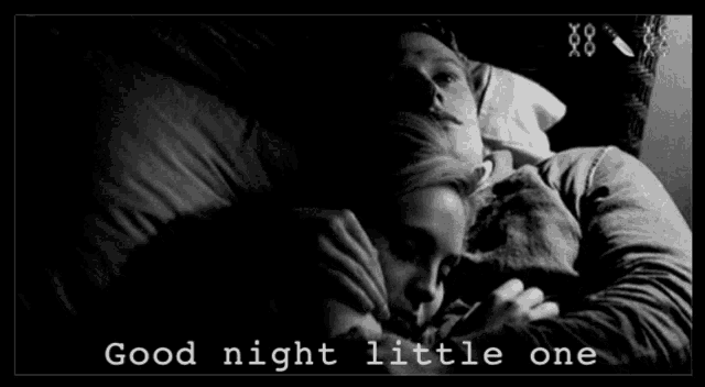 a black and white photo of a man and woman sleeping with the words good night little one below them