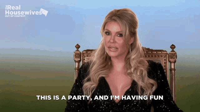 a woman is sitting in a chair with the words " this is a party and i 'm having fun "