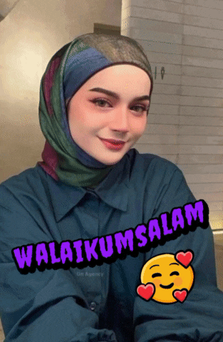 a woman wearing a hijab has a sticker that says " selamat " on it