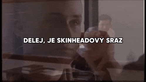a close up of a man 's face with the words ' delej je skinheadovy sraz ' written above him .