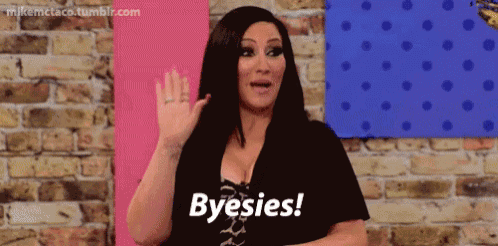 a woman is standing in front of a brick wall and says byesies