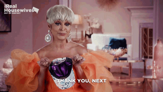 an advertisement for real housewives shows a woman holding a pair of shoes
