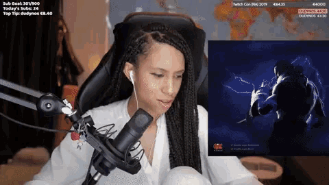 a woman is sitting in front of a microphone and a screen that says ' today 's subs : 24 ' on it