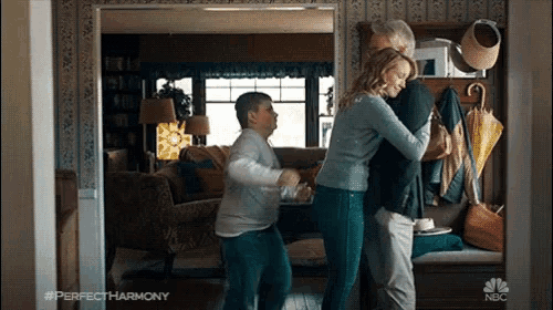 a scene from perfect harmony shows a family hugging