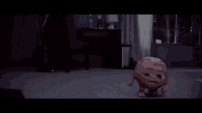 a cartoon character is walking on a carpet in a room .