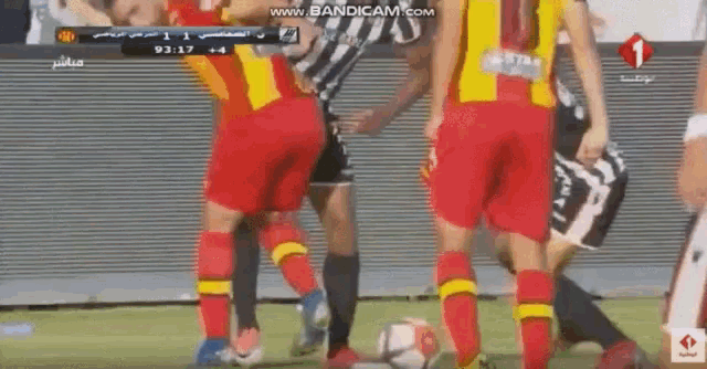 a group of soccer players are playing a game on a field sponsored by star