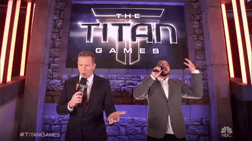 two men are singing in front of a sign that says the titan games