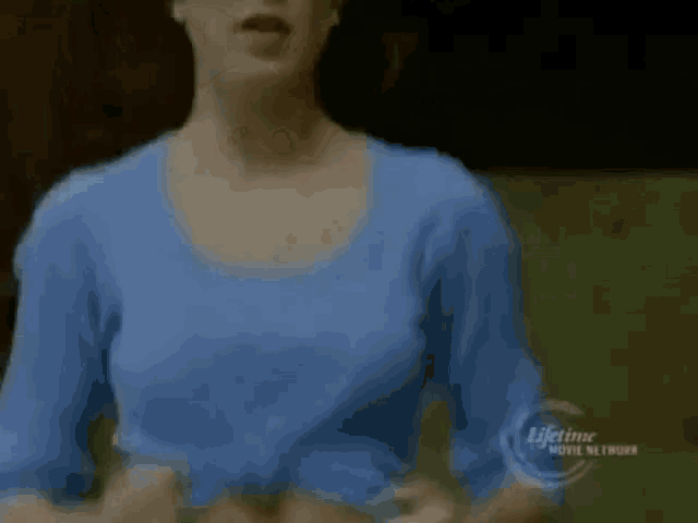 a woman in a blue shirt is on a lifetime movie network advertisement