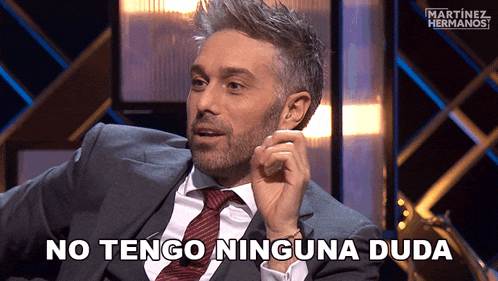 a man in a suit and tie is saying " no tengo ninguna duda "