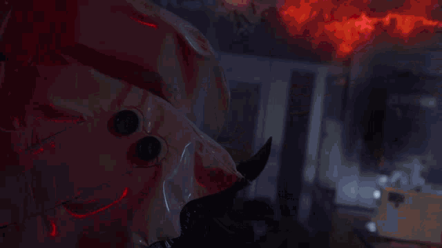 a close up of a red object that looks like a devil 's head