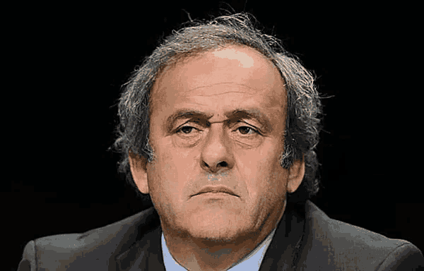 a close up of a man 's face with a serious look on his face