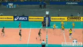 a volleyball game is being played on a court with asics and cimed advertisements