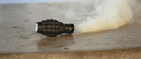 a black bomb with smoke coming out of it is on the ground