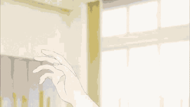 a person 's hand is reaching out towards another person 's face .