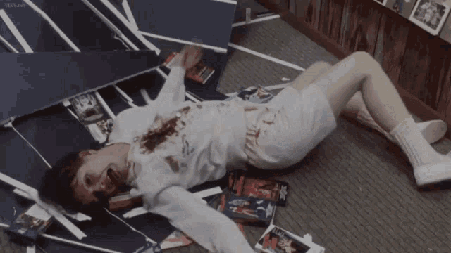 a man is laying on the floor with blood coming out of his mouth and a vhs laying on the ground