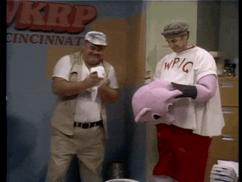 two men are standing in front of a wall that says krp cincinnati on it